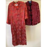 A vintage red rayon oriental pattern long housecoat with mandarin collar and turn back cuffs