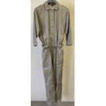 A 1980's womens leather jumpsuit in taupe coloured soft leather, with front press stud fastening and