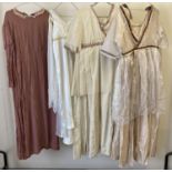 4 vintage theatre costume dresses in neutral tones.