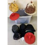 A box of assorted theatre costume hats in varying styles and sizes.