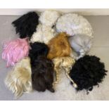 A quantity of theatre costume wigs, in varying colours and styles.