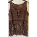 A 1970's vintage dark brown suede short waistcoat with long fringe hem and tie front. Bust approx 34