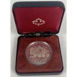 A boxed Canadian 1981 silver dollar with locomotive detail to reverse. Complete with protective