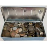 A vintage blue metal savings tin containing a collection of vintage British and foreign coins. To