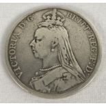 An 1890 Victoria Jubilee head silver crown with St. George slaying the dragon to reverse.