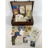 A small vintage leather suitcase containing a collection of mixed vintage ephemera. To include