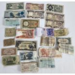 A collection of 23 foreign bank notes in varying sizes and conditions. To include examples from: