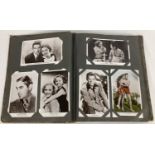 A vintage postcard album containing a collection of film studio black and white and coloured