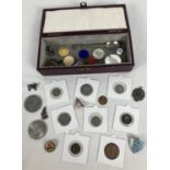 A small red box containing a collection of antique and vintage British and foreign coins. To include