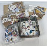 A quantity of assorted vintage loose British and world stamps.