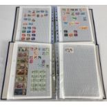 2 blue ring binders containing a quantity of assorted vintage world stamps.