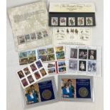 A small collection of stamp sets together with 2 Royal Commemorative coins. Stamps include: