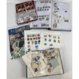 A collection of assorted world stamps and stamp albums.