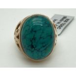 A modern design silver dress ring set with an oval cabochon of turquoise, by The Genuine Gem