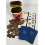 A small tin of vintage British coins mostly pennies and half pennies. Together with 4 Britain's