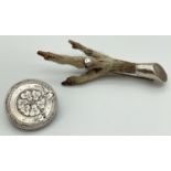 2 vintage silver and white metal brooches. A circular brooch with engraved floral, buckle and belt