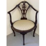 A late Victorian mahogany oval seated corner arm chair with carved & inlaid detail. Cream