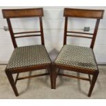 A pair of Georgian walnut curved back dining chairs with channelled detail and square legs. With