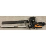 A Worx WA3512 18V rechargeable hedge trimmer with charger, battery and blade cover.