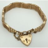 A 9ct yellow gold 5 bar gate bracelet with heart shaped padlock clasp & safety chain. Stamped 9 &