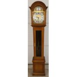 A mid century light wood cased Tempus Fugit grandmother clock. Brushed brass face with decorative