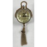 A brass bound ball watch pendant with tassel detail, roman numeral markers & hinged pendant bale.
