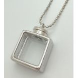 A modern design glass panel square shaped silver bottle pendant on a 30" oval silver bead chain with