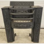 A Victorian cast iron fire grate with curve fronted basket and decorative scroll & foliate detail.
