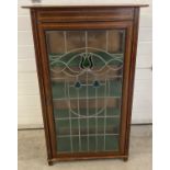 A Victorian mahogany display cabinet with leaded stained glass door& inlaid detail. 3 interior baize