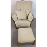 A modern Ercol light elm framed armchair and matching footstool, with cream coloured cushions.