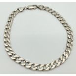 A 9.5 inch silver curb chain bracelet with lobster style clasp. Silver marks to clasp and fixings.