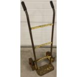 A vintage metal sack barrow, originally painted yellow, with rubber grip handles and wheels. Approx.