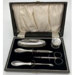 A 1930's silver manicure set in original black velvet lined case. All fully hallmarked for