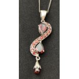 A modern design silver Swirl shape drop pendant set with teardrop, round and faceted garnets. On