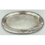 A Sterling silver oval shaped pin tray with oriental deity decoration to four sides. Back marked "