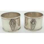 A pair of vintage sterling silver napkin rings with oriental deity decoration to front and back.