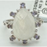 A modern design moonstone and tanzanite set silver dress ring by Gemporia. Central teardrop