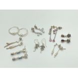 8 pairs of of silver, white metal and costume jewellery earrings in hoop and drop styles. To include