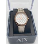 A ladies Armani Exchange wristwatch with leather strap. Rose gold tone case with quilted design face