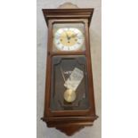 A vintage wooden cased Metamec Westminster chiming, 8 day weight driven wall clock. Complete with