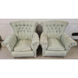 A pair of 1930's curve backed low armchairs on caster feet. Reupholstered with green foliate