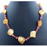 A 16" dyed freshwater pearl and shell beaded necklace with white metal T bar clasp. Retired