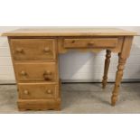 A vintage pine 4 drawer dressing table/desk with knob handles and turned legs. Approx. 73cm tall x