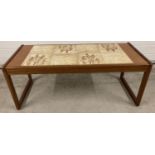 A 1970's teak tile topped coffee table with wheat design, by Sunelm. Approx. 42 x 105 x 45.5cm.