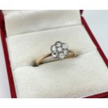 An antique 18ct gold and diamond flower cluster ring. Marked 18ct inside band, ring size L½. Total