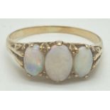 A vintage gold and opal set trilogy ring with scroll detail to mount. Very worn gold marks to inside