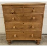 A vintage pine 2 over 3 chest of drawers with chunky bun front feet. Replacement knob handles and