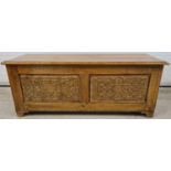 A vintage medium oak linen chest with decorative carved panel detail to front & sides. Approx.