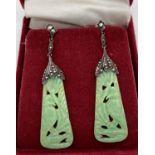 A pair of antique carved jade drop earrings with 935 silver mounts set with marcasites. Screw back