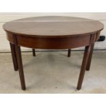 A Victorian mahogany 2 sectional circular dining table with 2 additional extending leaves. Each half